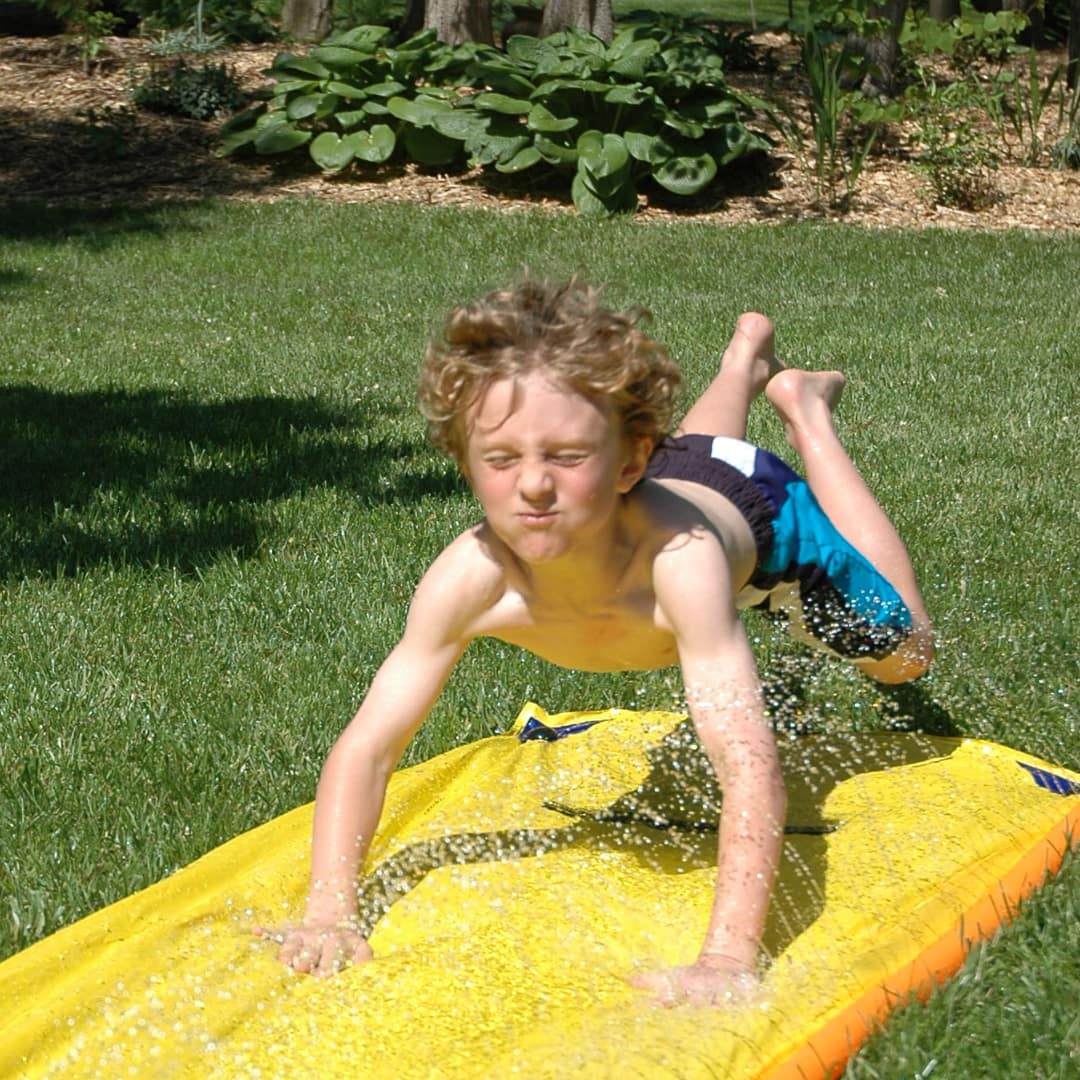image of teen on slip and slide